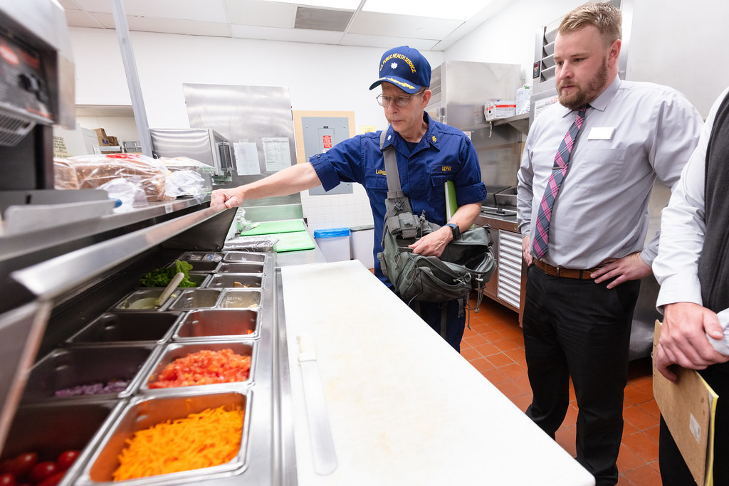 Commander George Larsen, Public Health Consultant, inspecting food services (2) — illustrating Fractional Chief Marketing Officer